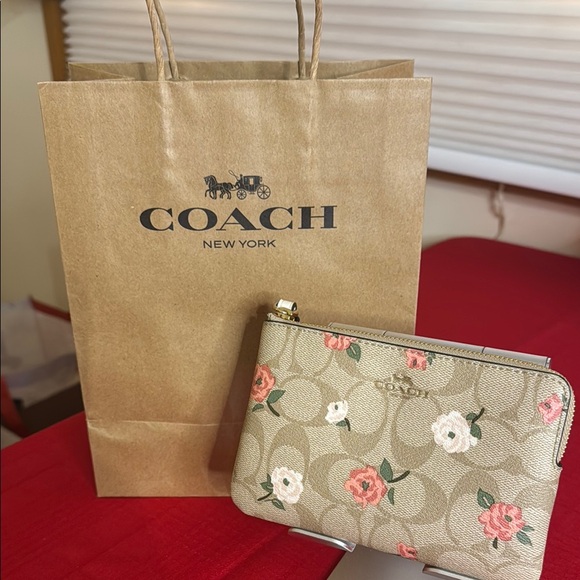 Coach Handbags - Coach Floral Beige Wristlet. NWT